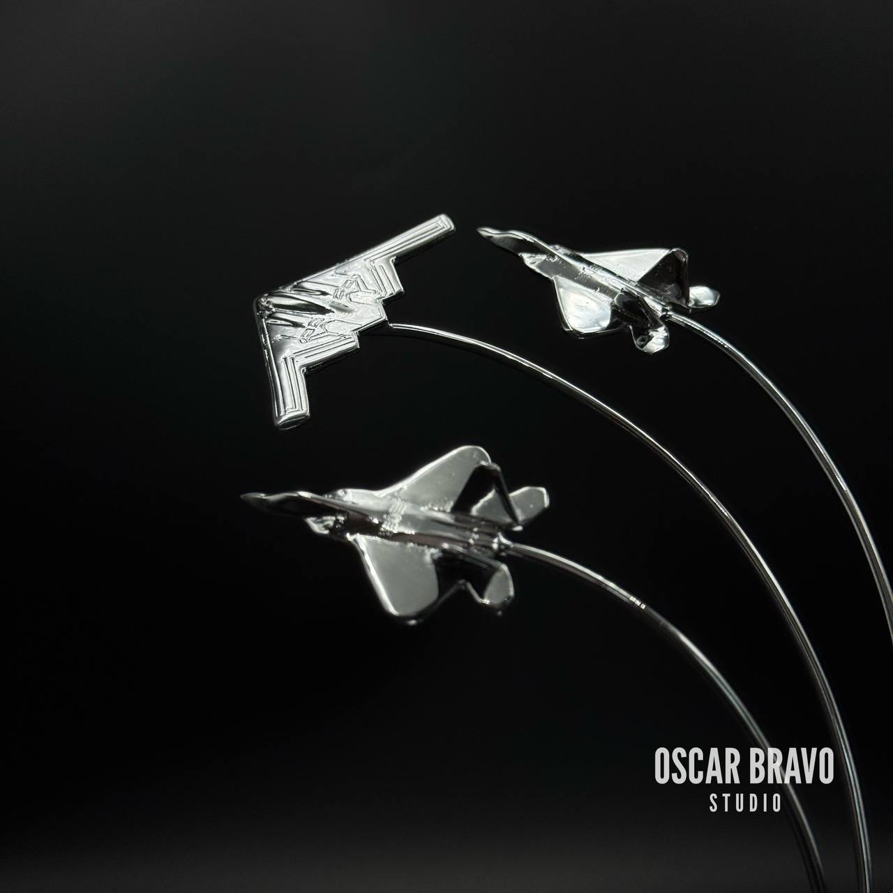 Handcrafted brass aircraft model featuring a B2 Spirit bomber in the center with two F22 fighter jets on each side, chrome-plated finish, 5.7-inch tall aviation desk decor for pilots and collectors.