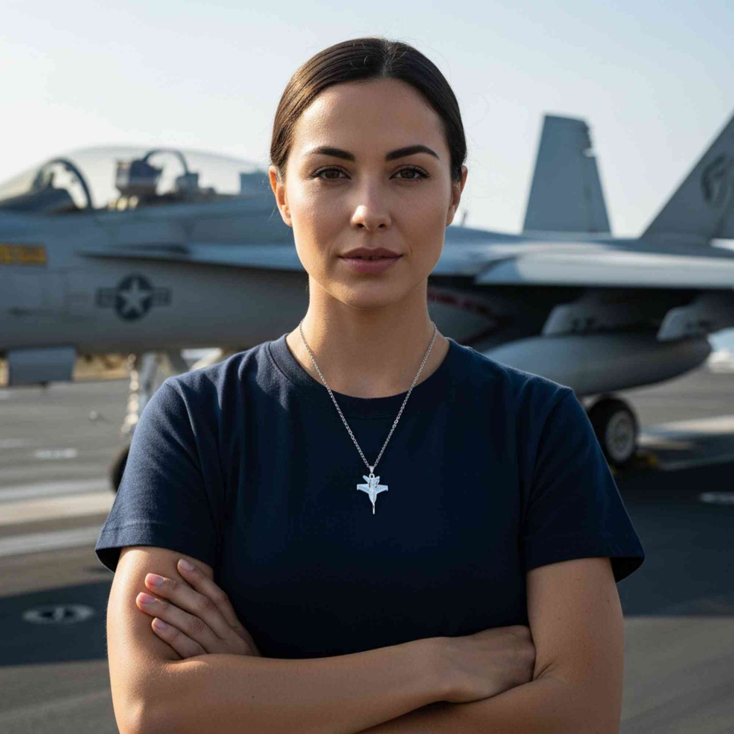 Woman standing in front of fighter jets with a necklace featuring a star pendant.