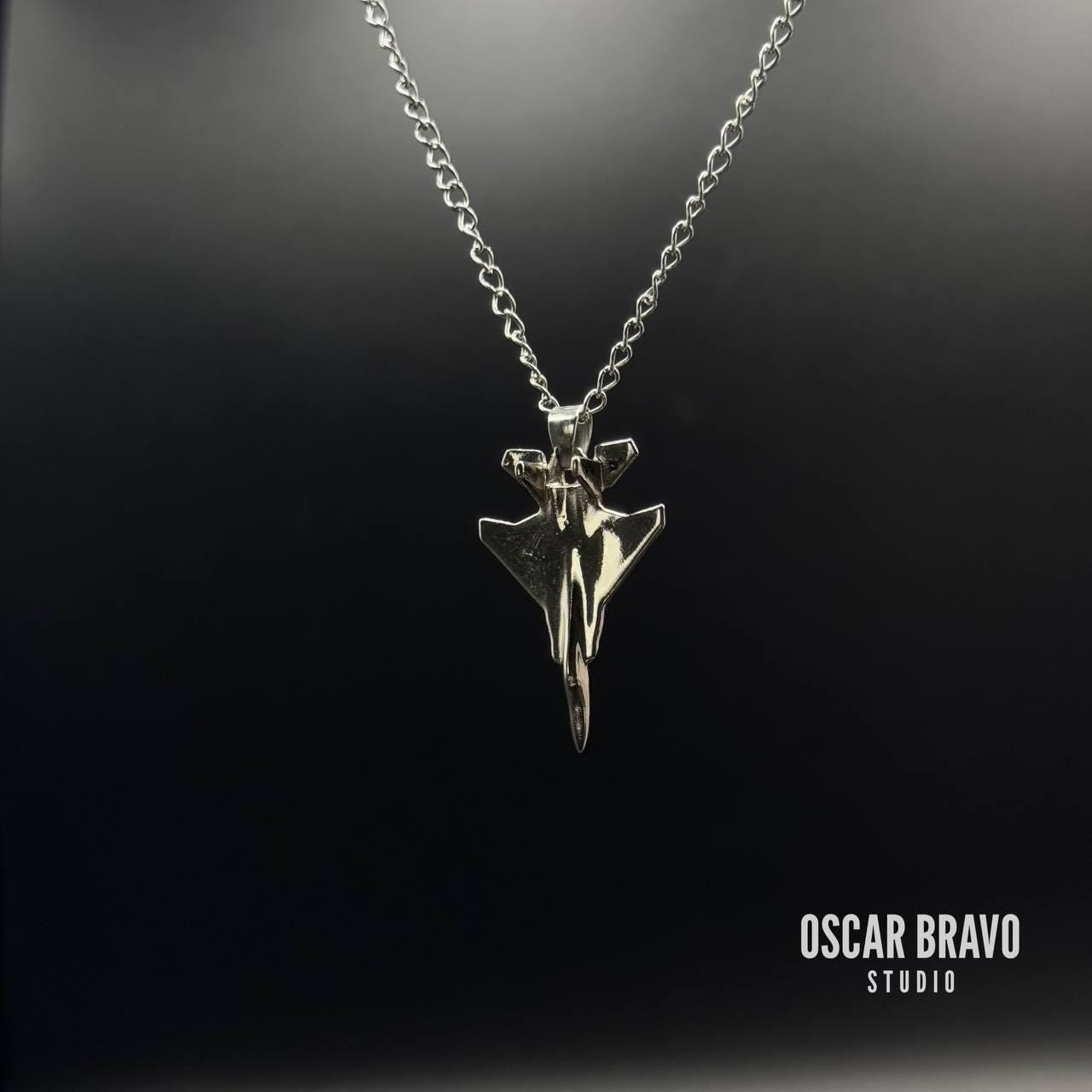 Silver necklace with a unique pendant on a black background, branded 'Oscar Bravo Studio'.